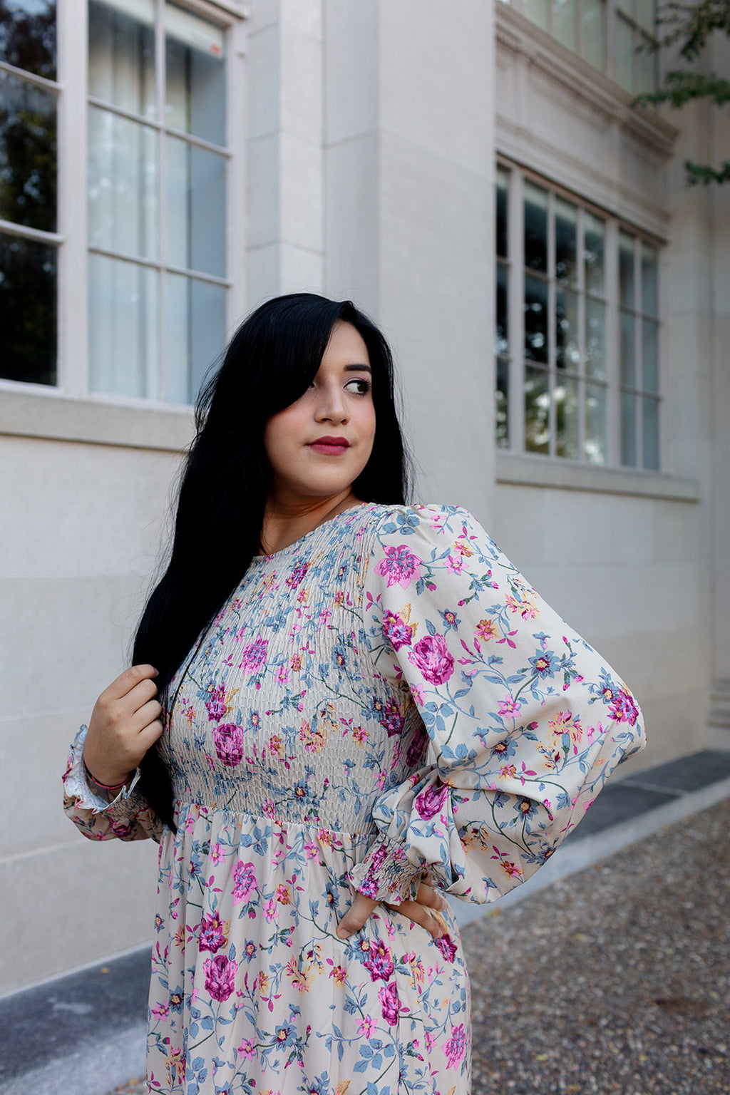 Long-sleeve floral print maxi dress with pink and purple flowers, modeled outdoors against a historic stone wall