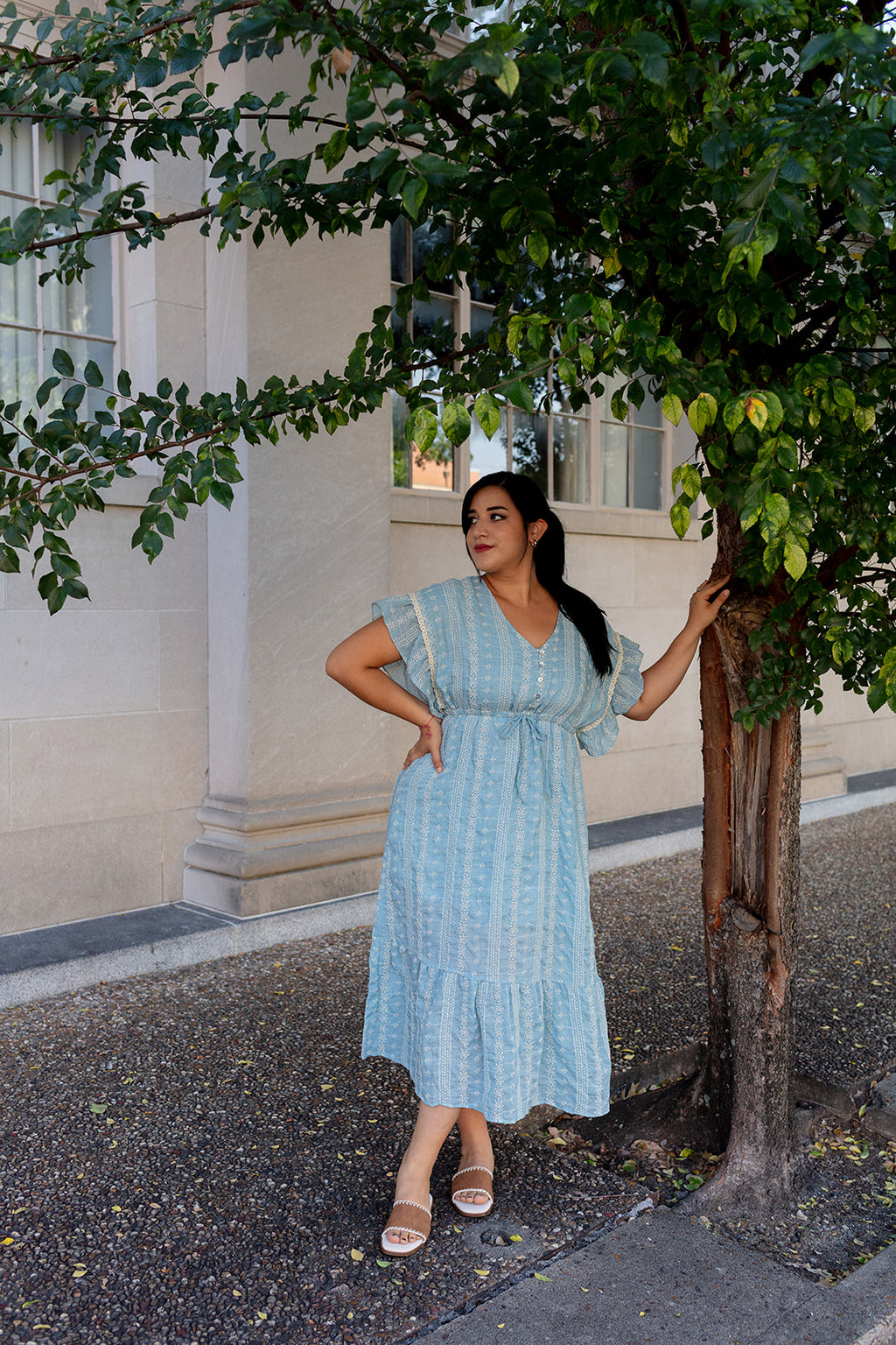 Woman wearing light blue boho midi dress with flutter sleeves