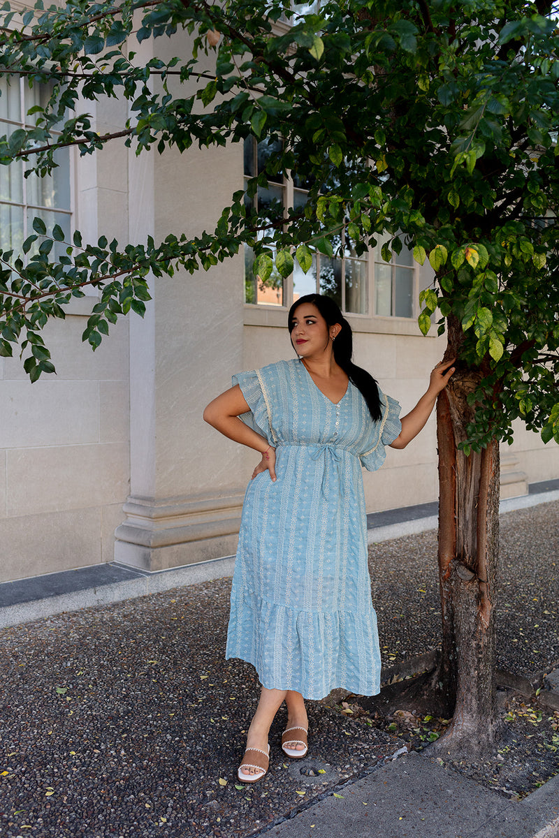 Woman wearing light blue boho midi dress with flutter sleeves