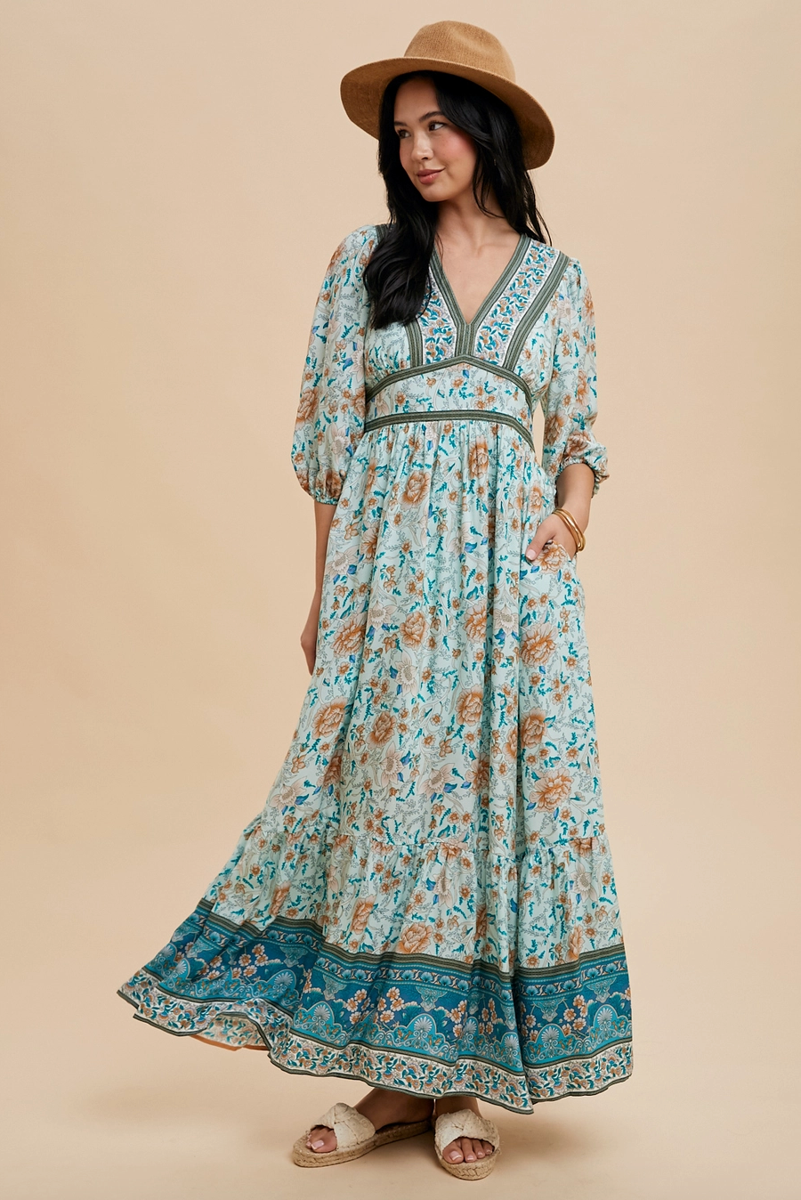 Woman wearing a floral dress with a beige background