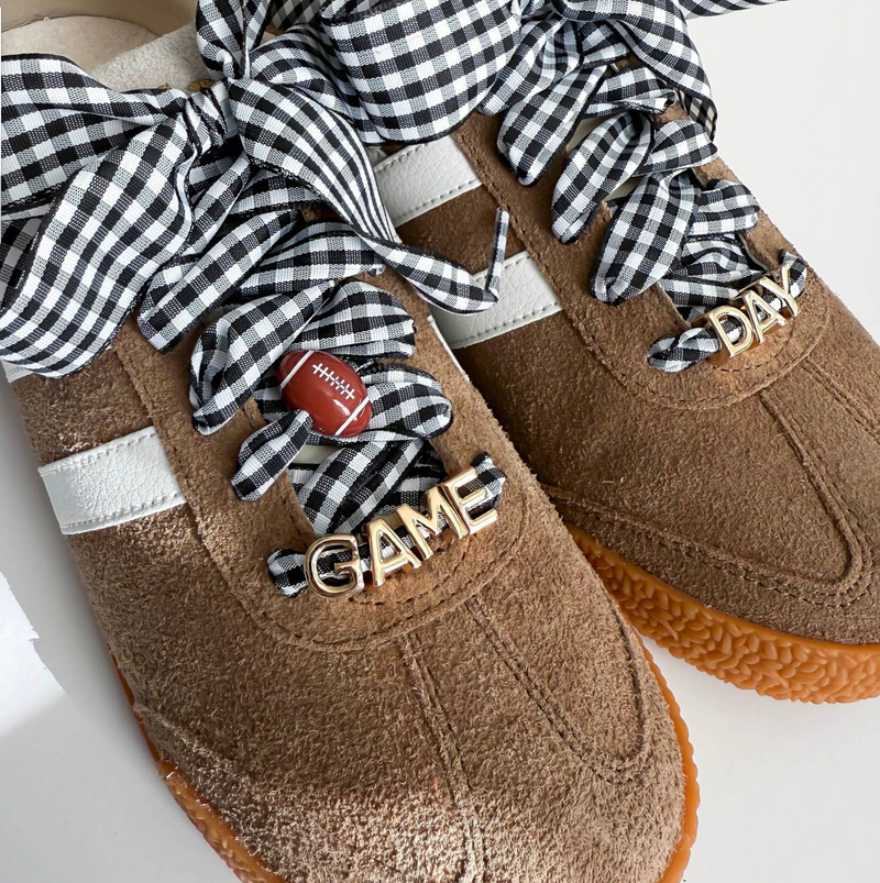 Brown shoes with checkered ribbons and 'GAME' and 'DAD' text on a white background